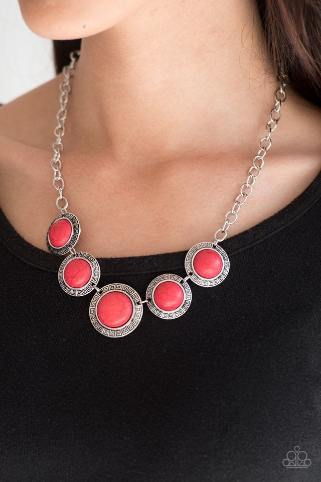 Chiseled into tranquil circles, smooth red stones are pressed into ornate silver frames and linked below the collar for a tribal inspired look. Features an adjustable clasp closure.